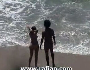 African and milky girls sunbathing on bare beach