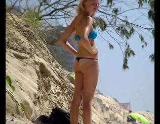 Teenager lengthy legged platinum-blonde sunbathing in panty
