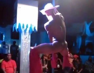 Muscular masculine stripper clothed like cowboy dancing at